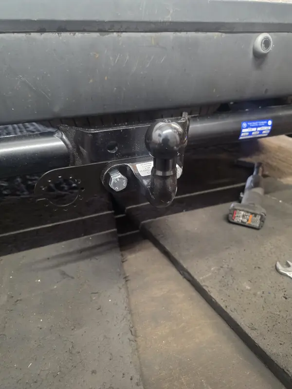 New tow bar with tow ball fitted under the rear bumper of a 2008 Ford Transit Connect