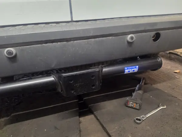 Tow bar cross-bar and mounting plate fitted under the back of a 2008 Ford Transit Connect